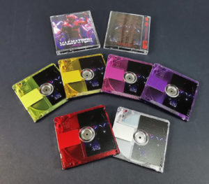 A set of six different colour printed MiniDiscs, using clear base discs and then printing transparent colour front windows and full colour backs of the MiniDiscs