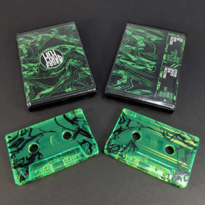Transparent green cassette tapes with a black full coverage print in black rave cases