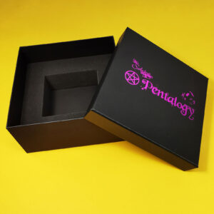 Seven cassette tape box set with a magenta foil lid print, showing the empty foam insert