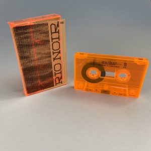 Transparent orange cassette tapes and cases, both with black on-body printing