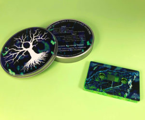 Transparent green cassette tapes in metal tins with printed lids and bases