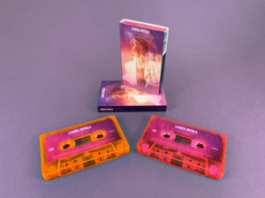 Transparent pink and orange cassette shells with sticker printing in full colour printed O-cards