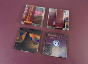 Clear MiniDiscs with full colour front print and transparent back print in jewel cases with J-cards finished with Obi strips