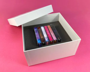 Six cassette tape box set with white foil lid and base print and custom foam insert to hold cassette tapes