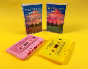 Pink and yellow cassette shells with sticker printing in clear cases with full colour J-cards