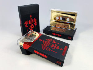 Gold mirror cassette tapes in black card cigarette pack cases with red hot foil printing and red metallic liners