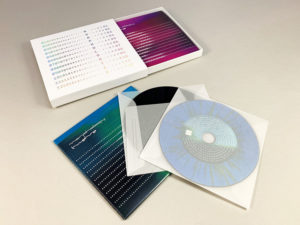 A four CD matchbox set with holographic silver foil printing on the matchbox and four custom printed vinyl-style CDs in tracing paper and card wallets.