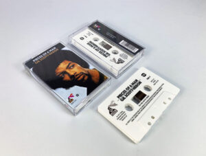 White cassette shells with black on-body print in clear cases with full colour 3 panel J-cards