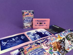 Pink cassette shells with blue on-body print in clear cases with full colour 7 panel J-cards