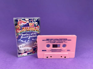 Pink cassette shells with blue on-body print in clear cases with full colour 7 panel J-cards