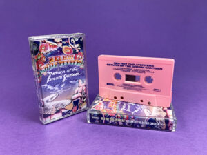 Pink cassette shells with blue on-body print in clear cases with full colour 7 panel J-cards