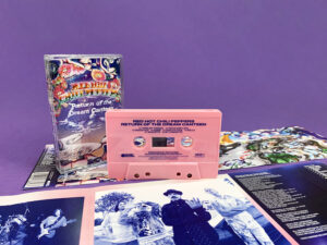 Pink cassette shells with blue on-body print in clear cases with full colour 7 panel J-cards