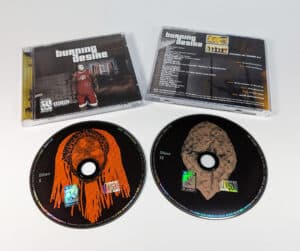 Double black base silk screen printed discs in standard depth double CD cases with CD posters