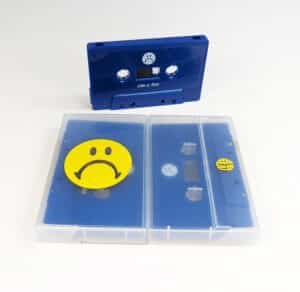 Solid dark blue cassette tapes in clear frosted cases with yellow on-body case prints